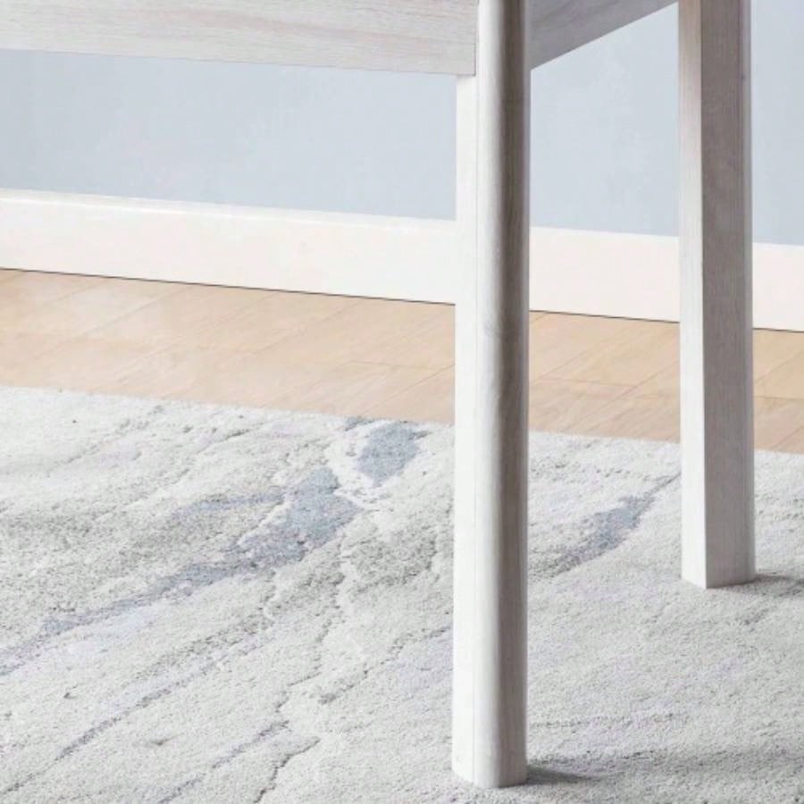 Faux marble white dining table top Four rounded leg posts Rounded table corners White Oak leg color