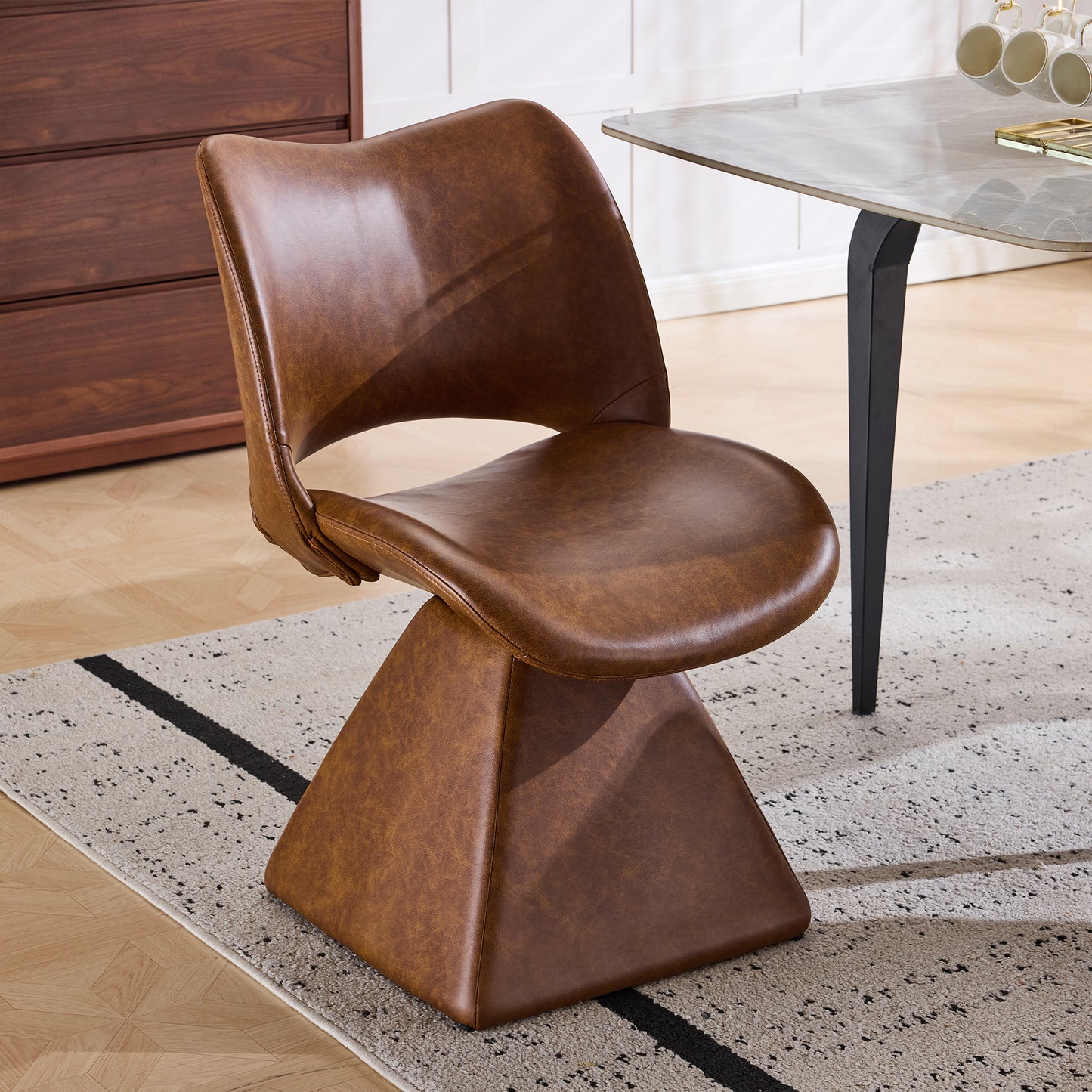 The swivel dining chair combines modern craftsmanship and can be combined in multiple sets. It is comfortable, artificial leather brown, and upholstered with modern high-back tables and chairs.