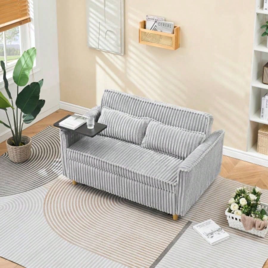 pull - out and push - in black corduroy sofa with dual functions, equipped with a movable tabletop and USB ports, is suitable use in living rooms and bedrooms.