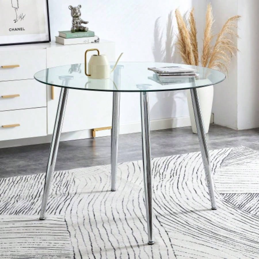 A glass tabletop with a diameter of 38.6 inches and a modern minimalist circular dining table with silver metal. Suitable living rooms, and conference rooms.