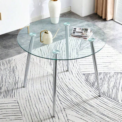 A glass tabletop with a diameter of 38.6 inches and a modern minimalist circular dining table with silver metal. Suitable living rooms, and conference rooms.