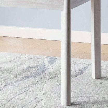 Faux marble white dining table top Four rounded leg posts Rounded table corners White Oak leg color