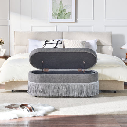 Oval Upholstered Storage Ottoman with Fringe Trim & Lift-Top Lid - 39"L x 16"W x 17"H, Multi-Functional Footrest & Hidden Storage for Living Room or Bedroom - Grey Fabric with Metal Frame