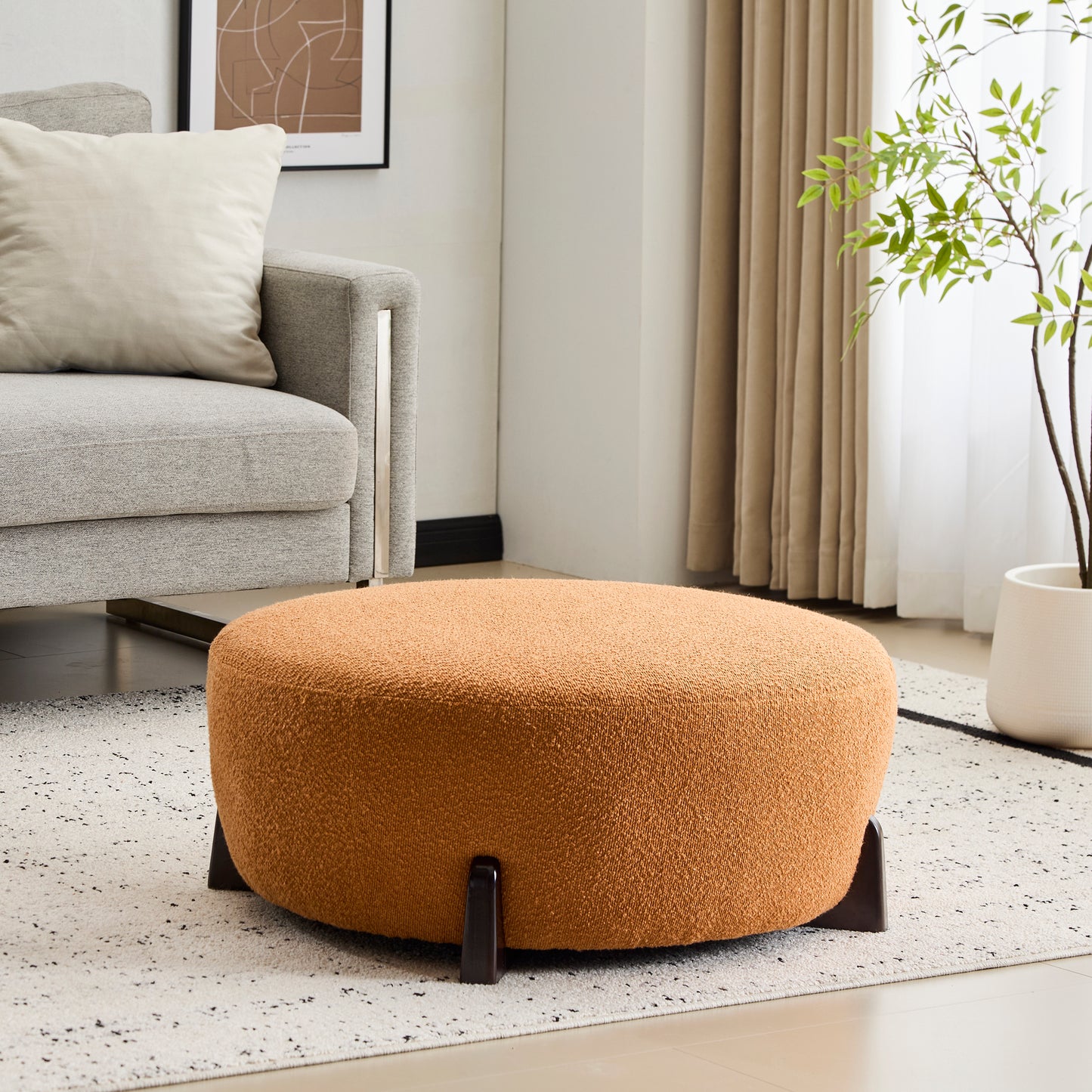 Modish Round Ottoman: Boucle Top with Splayed Rubber Wood Legs, Pumpkin Orange