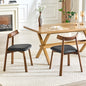 2 walnut colored solid wood dining chairs, with black PU soft cushions and curved backrests that fit the curves of the back, suitable for home dining.