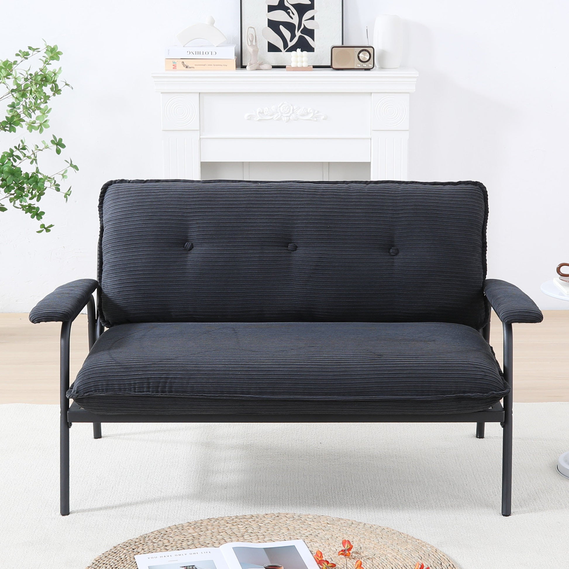The 53-inch black sofa offers a spacious layout in the small apartment, easily handling various scenarios from watching movies to working